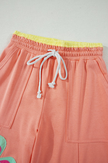 Pantalón de pierna ancha con cordón y cintura elástica contrastada, estampado floral en bloques de color naranja y pomelo