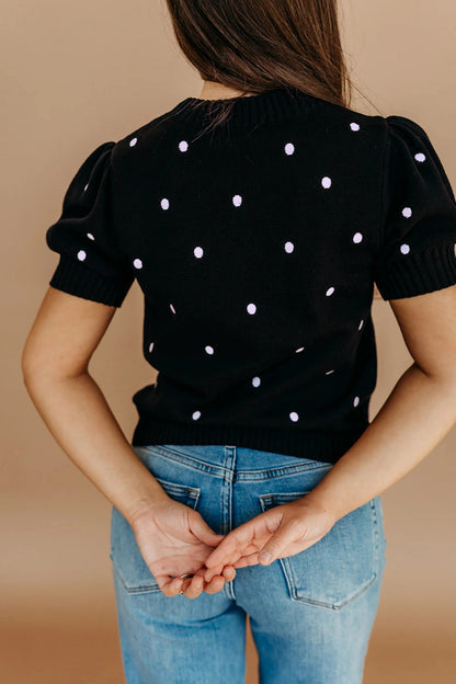 Suéter negro elegante de burbujas con lunares y manga corta