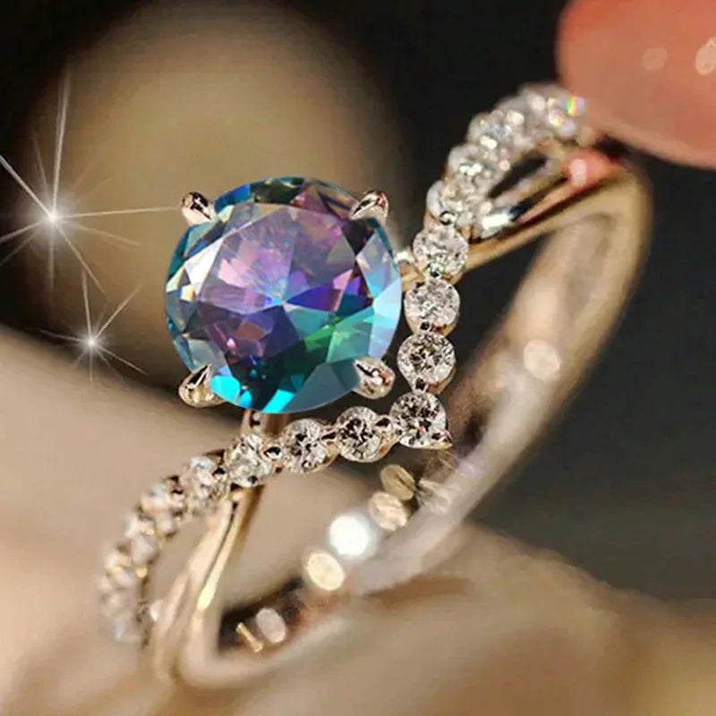 Anillo de compromiso de circonita cúbica de acero inoxidable colorido para mujer, con piedra redonda creada en laboratorio, engaste de puntas y detalles de diamantes H317