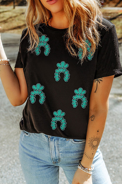 Camiseta negra con lentejuelas y parches, diseño turquesa del Oeste