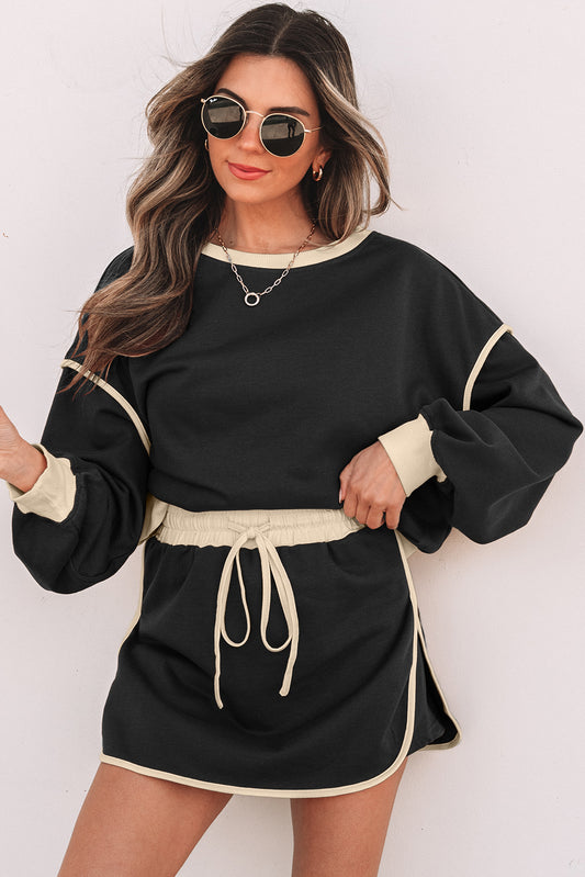 Conjunto de falda pantalón con contraste de color negro y jerséi holgado con cordones en la cintura