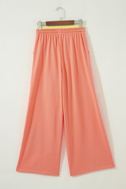 Pantalón de pierna ancha con cordón y cintura elástica contrastada, estampado floral en bloques de color naranja y pomelo